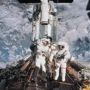 Astronauts John Grunsfeld and Richard Linnehan near the Hubble Space Telescope, temporarily hosted in the space shuttle Columbia’s cargo bay, March 8, 2002.